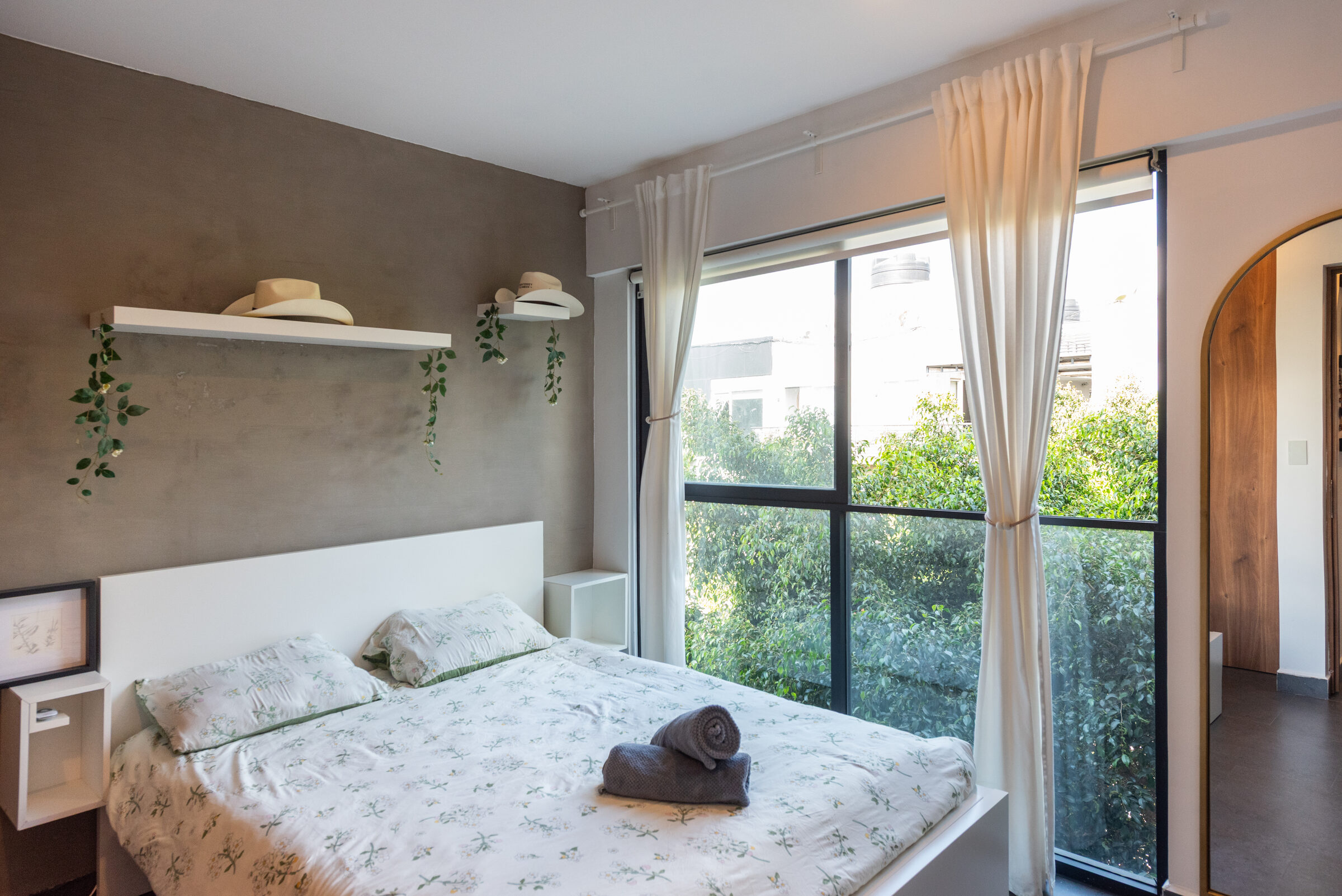 Primary bedroom with floor-to-ceiling glass