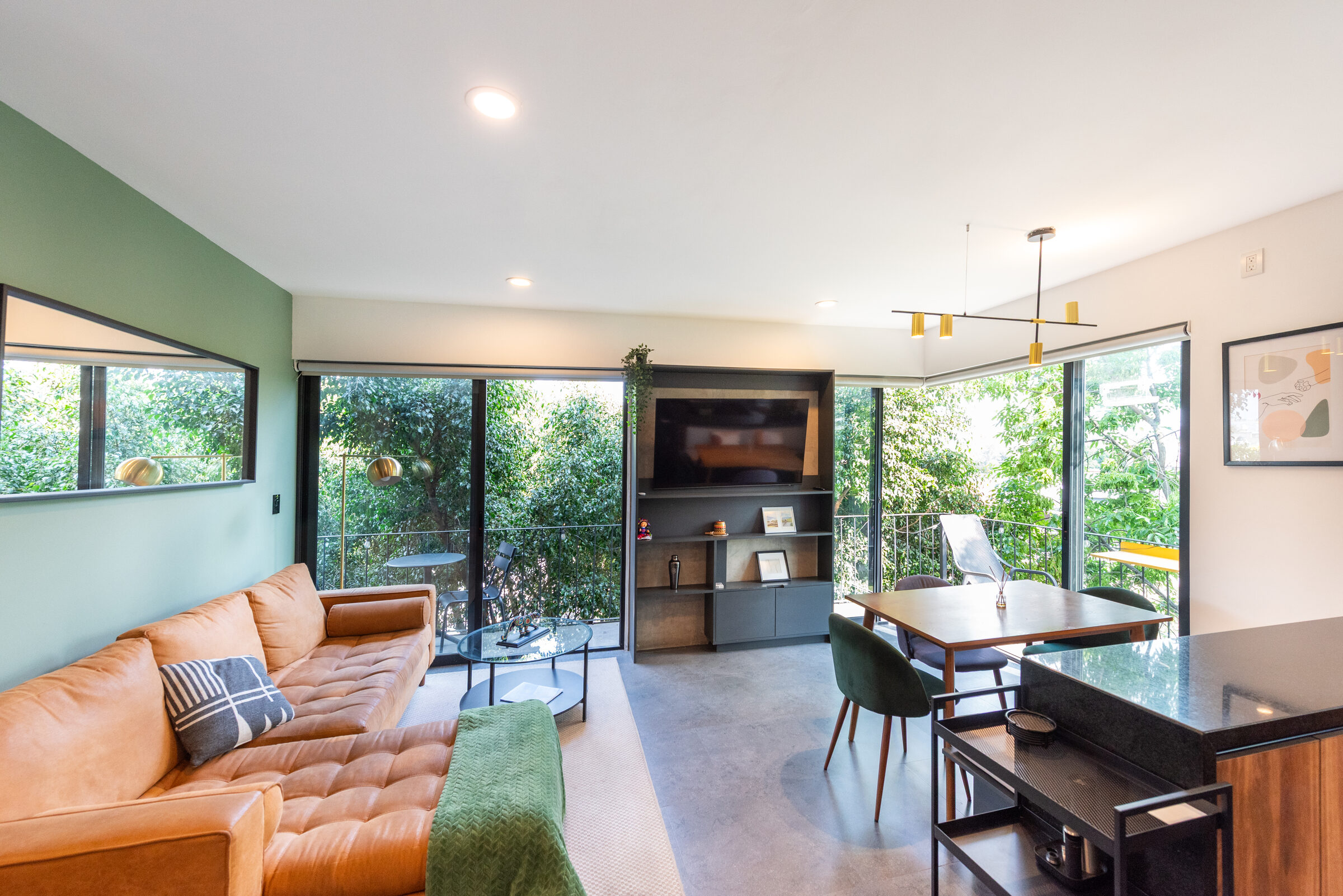 Living and dining with floor-to-ceiling glass on two exposures