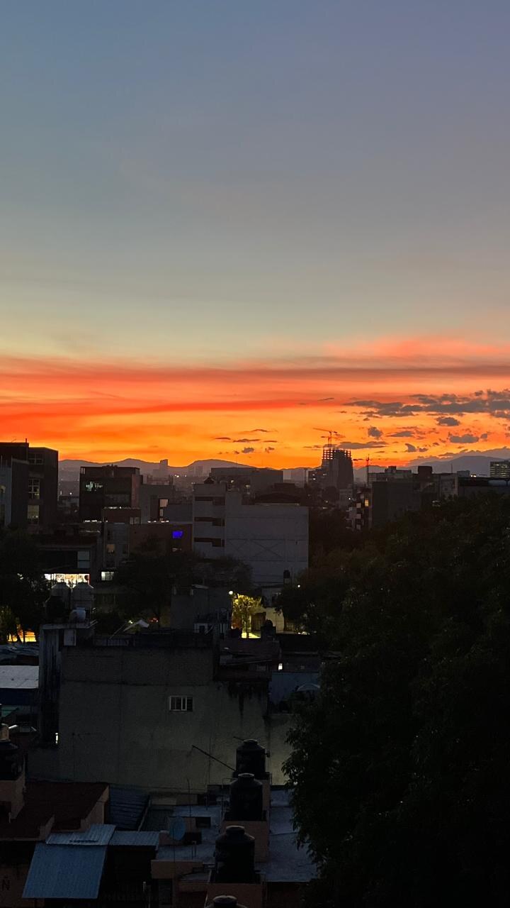 Sunset over the Mexico City skyline from the rooftop